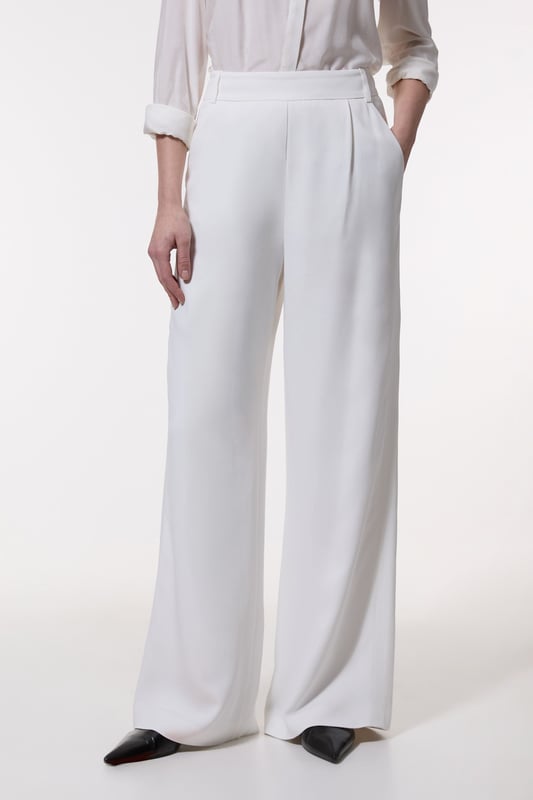Experience elevated tailoring in a pair of wide leg trousers, with a flattering, relaxed fit and a comfortable high waistline. The sleek design makes them easy to style with anything, from a button up shirt for a formal look, or with a T-shirt and trainers for a more laid back approach. Compact Stretch Viscose Wide Leg Tailored Trouser High Quality Stretch Fabic Comfortable High Waistline Flattering Wide Leg Fit Sleek, Minimal Design Matching Pieces Sold Separately