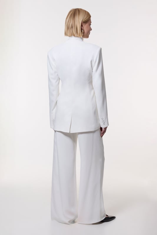 Experience elevated tailoring in a pair of wide leg trousers, with a flattering, relaxed fit and a comfortable high waistline. The sleek design makes them easy to style with anything, from a button up shirt for a formal look, or with a T-shirt and trainers for a more laid back approach. Compact Stretch Viscose Wide Leg Tailored Trouser High Quality Stretch Fabic Comfortable High Waistline Flattering Wide Leg Fit Sleek, Minimal Design Matching Pieces Sold Separately