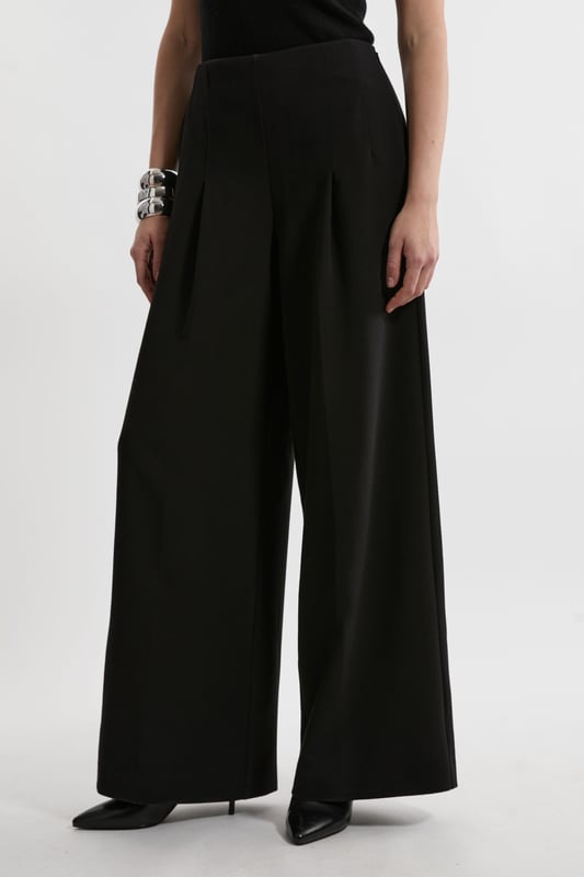 Experience elevated tailoring in a pair of wide leg trousers, with a flattering, relaxed fit and a comfortable high waistline. The sleek design makes them easy to style with anything, from a button up shirt for a formal look, or with a T-shirt and trainers for a more laid back approach. Compact Stretch Essential Wide Leg Tailored Trouser High Quality Stretch Fabic Comfortable High Waistline Flattering Wide Leg Fit Sleek, Minimal Design