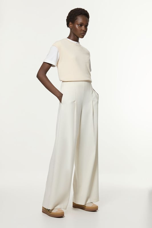 Experience elevated tailoring in a pair of wide leg trousers, with a flattering, relaxed fit and a comfortable high waistline. The sleek design makes them easy to style with anything, from a button up shirt for a formal look, or with a T-shirt and trainers for a more laid back approach. Compact Stretch Essential Wide Leg Tailored Trouser High Quality Stretch Fabic Comfortable High Waistline Flattering Wide Leg Fit Sleek, Minimal Design