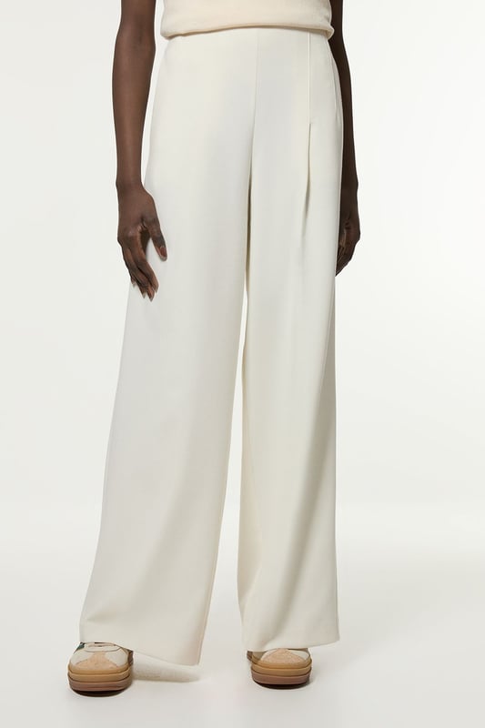 Experience elevated tailoring in a pair of wide leg trousers, with a flattering, relaxed fit and a comfortable high waistline. The sleek design makes them easy to style with anything, from a button up shirt for a formal look, or with a T-shirt and trainers for a more laid back approach. Compact Stretch Essential Wide Leg Tailored Trouser High Quality Stretch Fabic Comfortable High Waistline Flattering Wide Leg Fit Sleek, Minimal Design
