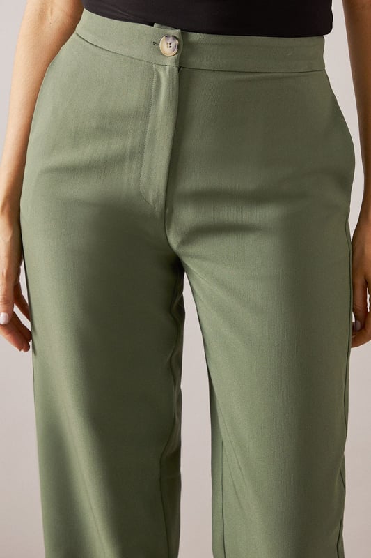 Tailored tapered design for a sophisticated silhouette
        Comfortable regular fit with a flattering waistline
        Versatile woven fabric suitable for various occasions
        Sleek side pockets for practicality and style
        Full-length trousers with a modern straight leg
    
    Embrace effortless elegance with these tailored tapered trousers from Wallis. Perfect for the woman who appreciates both comfort and style, these trousers offer a regular fit that flatters various body types. The tapered design creates a sleek silhouette, making them ideal for casual daywear or smart-casual events. Style them with a crisp white blouse and trainers for a chic everyday look, or pair them with a matching blazer for a coordinated ensemble that's perfect for family gatherings or casual work environments. The versatile nature of these trousers allows for easy transition from day to night - simply swap your flats for a pair of low heels and add some statement jewellery for an evening out. With their timeless design and comfortable fit, these trousers are sure to become a staple in your wardrobe, offering endless styling possibilities for the sophisticated woman on the go.