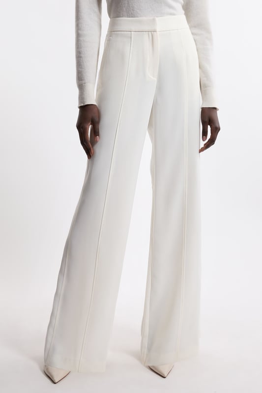 Experience elevated tailoring in a pair of straight leg trousers, featuring a flattering, relaxed fit, seam detailing for a seamless fit, and a comfortable high waistline. The sleek design makes them easy to style with anything, from a crisp button up shirt for a formal look, or with a T-shirt and trainers for a more laid back approach. Tailored Crepe Seam Detail Straight Leg Trousers High Quality Crepe Fabric Comfortable High Waistline Flattering Straight Leg Fit Statement, Pronounced Seam Detailing Pocket Accents Sleek, Minimal Design