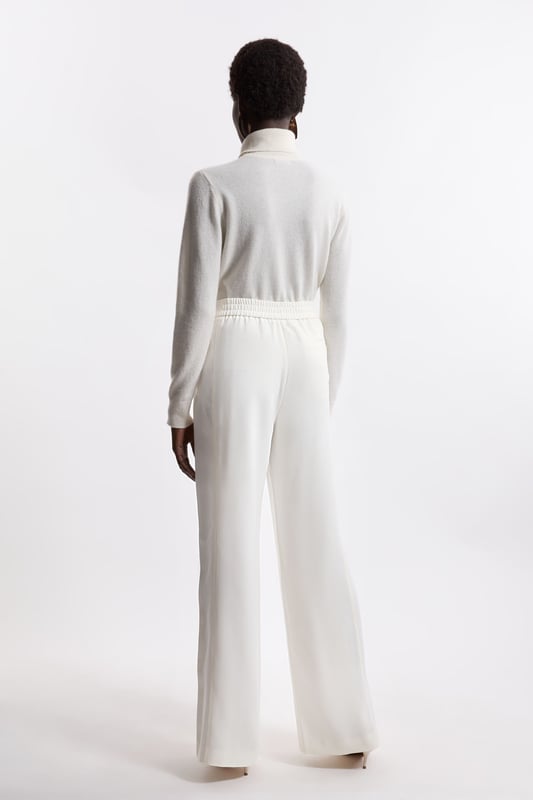 Experience elevated tailoring in a pair of straight leg trousers, featuring a flattering, relaxed fit, seam detailing for a seamless fit, and a comfortable high waistline. The sleek design makes them easy to style with anything, from a crisp button up shirt for a formal look, or with a T-shirt and trainers for a more laid back approach. Tailored Crepe Seam Detail Straight Leg Trousers High Quality Crepe Fabric Comfortable High Waistline Flattering Straight Leg Fit Statement, Pronounced Seam Detailing Pocket Accents Sleek, Minimal Design