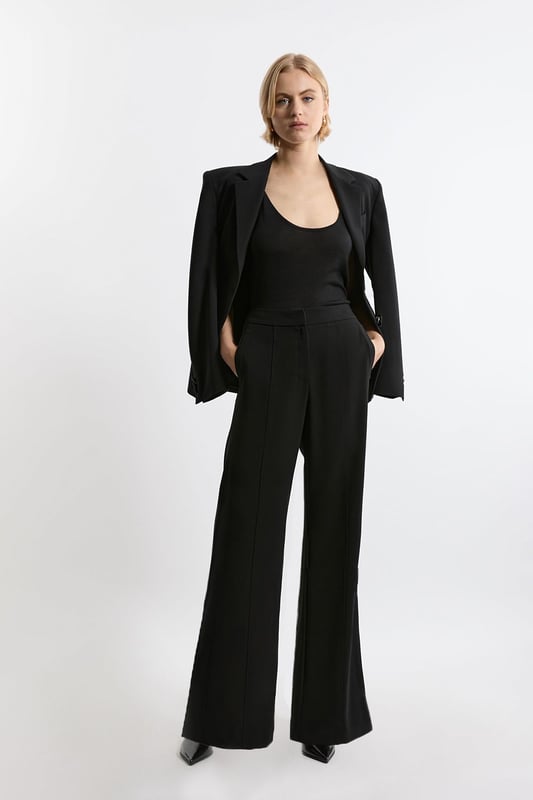Experience elevated tailoring in a pair of straight leg trousers, featuring a flattering, relaxed fit, seam detailing for a seamless fit, and a comfortable high waistline. The sleek design makes them easy to style with anything, from a crisp button up shirt for a formal look, or with a T-shirt and trainers for a more laid back approach. Tailored Crepe Seam Detail Straight Leg Trousers High Quality Crepe Fabric Comfortable High Waistline Flattering Straight Leg Fit Statement, Pronounced Seam Detailing Pocket Accents Sleek, Minimal Design