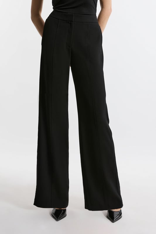 Experience elevated tailoring in a pair of straight leg trousers, featuring a flattering, relaxed fit, seam detailing for a seamless fit, and a comfortable high waistline. The sleek design makes them easy to style with anything, from a crisp button up shirt for a formal look, or with a T-shirt and trainers for a more laid back approach. Tailored Crepe Seam Detail Straight Leg Trousers High Quality Crepe Fabric Comfortable High Waistline Flattering Straight Leg Fit Statement, Pronounced Seam Detailing Pocket Accents Sleek, Minimal Design