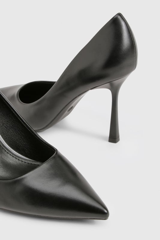 Sleek pointed toe design for a contemporary silhouette
        Elegant stiletto heel measuring between 7-9cm for comfortable height
        Smooth PU finish that maintains its polished appearance
        Classic slip-on style for effortless wear
        Versatile court shoe shape that complements any outfit
    
    These sophisticated pumps are the ultimate wardrobe essential that transition seamlessly from day to night. The pointed toe and perfectly proportioned heel create a flattering line that elongates the leg whilst maintaining comfort for all-day wear. Style with tailored trousers and a crisp blouse for office sophistication, or pair with your favourite jeans and a statement top for evening drinks. For special occasions, these versatile heels complement both midi and mini dresses beautifully. The sleek design works wonderfully with both structured and flowing garments, making these pumps a true style chameleon in your collection. Their timeless appeal ensures they'll remain a go-to choice season after season, offering endless styling possibilities for the fashion-forward woman.