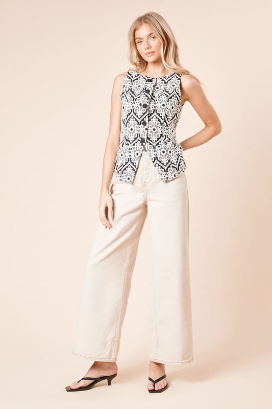 Sleeveless waistcoat top featuring intricate Cornelli embroidery in a striking geometric pattern
        Collarless neckline with button-through front for versatile styling options
        Crafted from pure cotton fabric for breathable comfort throughout the day
        Regular fit silhouette that flatters the figure without clinging
        Finished with a subtle curved hem that creates a flattering shape when worn untucked
    
    This charming Cornelli embroidered waistcoat top from Dorothy Perkins brings a touch of artisanal detail to your everyday wardrobe. The distinctive geometric embroidery pattern creates visual interest whilst maintaining a sophisticated aesthetic that works beautifully for casual daytime occasions. Style it as seen with wide-leg trousers and flat sandals for a relaxed brunch with friends, or pair with your favourite denim and trainers for family gatherings. The button-through design offers styling flexibility - wear fully buttoned for a more polished look or leave a few buttons undone for a relaxed feel. The cotton fabric ensures all-day comfort, making this top perfect for those busy days when you're dashing between coffee dates and school runs. A versatile piece that transitions effortlessly from spring through to autumn with simple layering.