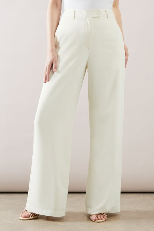Sleek longline waistcoat with a sophisticated collar
        Halterneck design for a modern, chic look
        Wide-leg trousers with a flattering high waist
        Side pockets for practicality and style
        Back split detail on trousers for ease of movement
    
    This collared longline waistcoat ensemble from Wallis is the epitome of contemporary sophistication. Perfect for the woman who appreciates glamour with a comfortable edge, this set is versatile enough for various occasions. The sleek waistcoat, featuring a halterneck design, pairs beautifully with the wide-leg trousers, creating a flowing silhouette that's both flattering and on-trend. For a casual yet polished look, style with minimalist jewellery and strappy sandals. When attending family gatherings or informal events, layer with a lightweight blouse underneath for added dimension. The ensemble's clean lines and elegant simplicity make it an ideal choice for those seeking a refined appearance without sacrificing comfort. Customise the look with a statement belt to define the waist or leave it open for a more relaxed feel. This Wallis piece promises to be a versatile addition to your wardrobe, ready to take you from day to night with effortless grace.