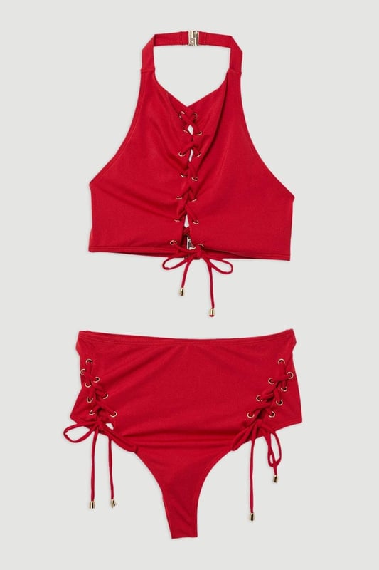 Experience elevated confidence in our halter neck bikini. This piece features a supportive design, accentuated with a strappy design and a secure full coverage design. Style this piece with the matching bikini bottoms and strappy sandals for a holiday outfit perfect for beach clubs, pool parties, and spa days. Slinky Tie Detail Bikini Top Supportive, Wide Shoulder Straps Statement Stitched Design Comfortable, Wide Shoulder Straps SecureFull Coverage Design Halter Bikini Top Style Metallic Clasp Fastenings in Back Matching Bikini Bottoms Sold Separately