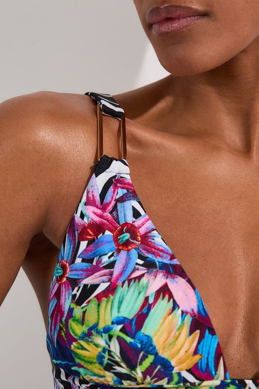 Make a splash this season with Karen Millen's eye-catching Tropical Floral Plunge Bikini Top. This striking piece combines an exotic floral pattern with zebra print elements. The plunging neckline adds a touch of allure, perfect for those seeking to make a statement poolside or on the beach. Adjustable straps ensure a customised fit, while the supportive under-bust band provides comfort for all-day wear. Whether you're lounging by the pool or enjoying a beachside cocktail, this bikini top is perfect for sunny days. Pair it with the matching bottoms for a coordinated look, or mix it up with a solid-coloured bottom to showcase your personal style. This Karen Millen piece is sure to become your go-to swimwear for hot destinations and summer getaways.  Vibrant tropical floral print with bold zebra accents Plunging neckline for a daring and alluring look Adjustable straps with sleek metal hardware Supportive under-bust band for enhanced comfort Versatile design suitable for mix-and-match styling