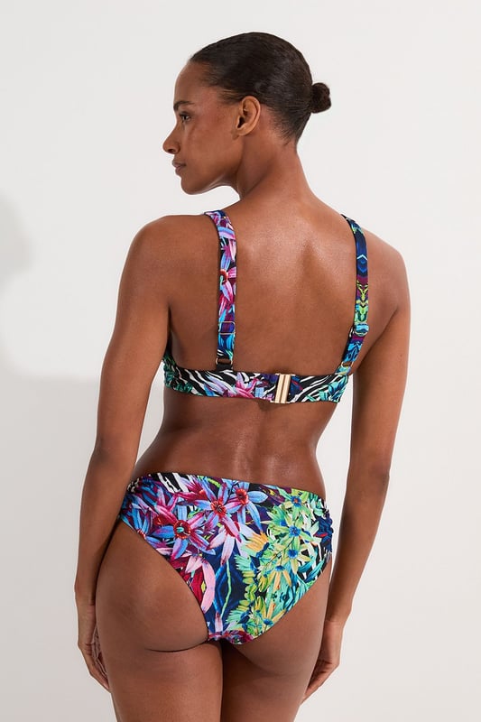 Make a splash this season with Karen Millen's eye-catching Tropical Floral Plunge Bikini Top. This striking piece combines an exotic floral pattern with zebra print elements. The plunging neckline adds a touch of allure, perfect for those seeking to make a statement poolside or on the beach. Adjustable straps ensure a customised fit, while the supportive under-bust band provides comfort for all-day wear. Whether you're lounging by the pool or enjoying a beachside cocktail, this bikini top is perfect for sunny days. Pair it with the matching bottoms for a coordinated look, or mix it up with a solid-coloured bottom to showcase your personal style. This Karen Millen piece is sure to become your go-to swimwear for hot destinations and summer getaways.  Vibrant tropical floral print with bold zebra accents Plunging neckline for a daring and alluring look Adjustable straps with sleek metal hardware Supportive under-bust band for enhanced comfort Versatile design suitable for mix-and-match styling