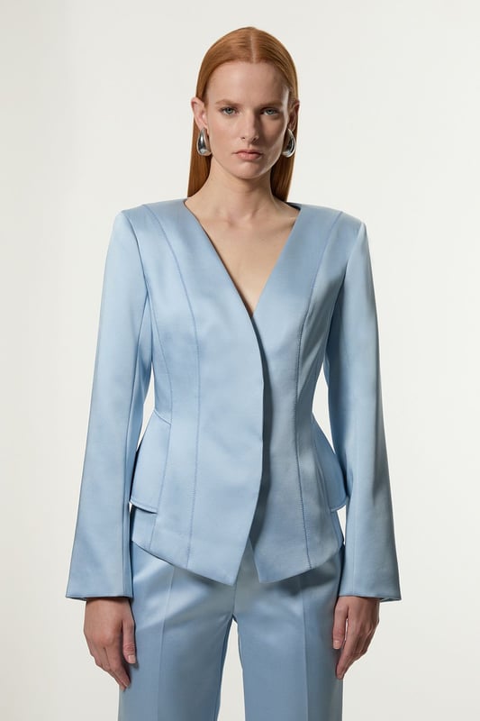 This Karen Millen blazer is a versatile piece that seamlessly transitions from day to night. The structured viscose satin fabric lends a sophisticated sheen, whilst the tailored peplum design creates a figure-flattering shape. Perfect for formal occasions, pair it with matching trousers for a chic suit ensemble or dress it down with dark-wash jeans for a smart-casual look. The stitch detailing adds a touch of refinement, making it an ideal choice for weddings, races, or important business meetings. Layer it over a silk camisole or crisp white shirt for added versatility. This blazer is a wardrobe essential that will serve you well for years to come, offering endless styling possibilities for the fashion-forward British woman.   Structured viscose satin fabric for a luxurious look and feel Tailored peplum design for a flattering silhouette Stitch detail adds subtle texture and visual interest V-neckline creates an elegant and feminine look Slim fit accentuates curves while maintaining a polished appearance