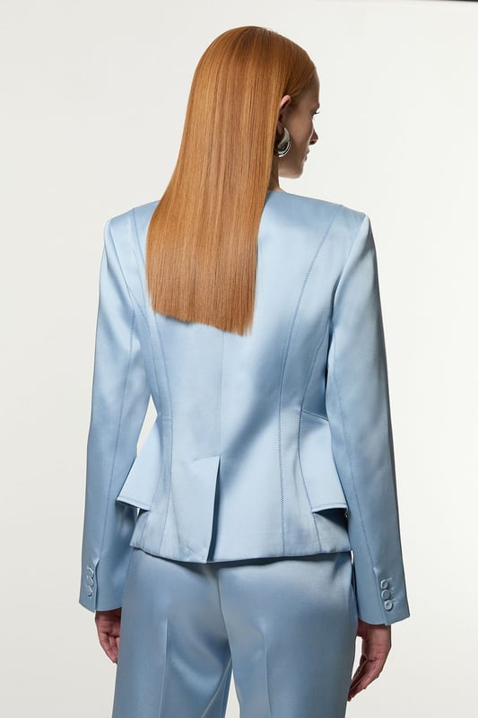 This Karen Millen blazer is a versatile piece that seamlessly transitions from day to night. The structured viscose satin fabric lends a sophisticated sheen, whilst the tailored peplum design creates a figure-flattering shape. Perfect for formal occasions, pair it with matching trousers for a chic suit ensemble or dress it down with dark-wash jeans for a smart-casual look. The stitch detailing adds a touch of refinement, making it an ideal choice for weddings, races, or important business meetings. Layer it over a silk camisole or crisp white shirt for added versatility. This blazer is a wardrobe essential that will serve you well for years to come, offering endless styling possibilities for the fashion-forward British woman.   Structured viscose satin fabric for a luxurious look and feel Tailored peplum design for a flattering silhouette Stitch detail adds subtle texture and visual interest V-neckline creates an elegant and feminine look Slim fit accentuates curves while maintaining a polished appearance