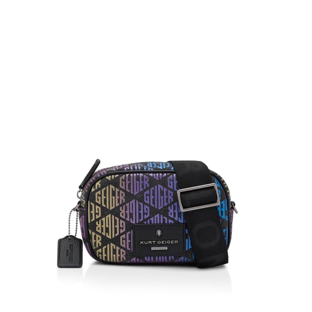 This Small Chiswick Camera Bag from Kurt Geiger features a dark rainbow ombre monogram print across the exterior of the bag. There is a black patch with antiqued silver logo on the front of the bag and open pocket on the back. Dimensions: 13cm (H), 19cm (L), 6cm (D) Strap length: 236cm Woven strap length: 121cm