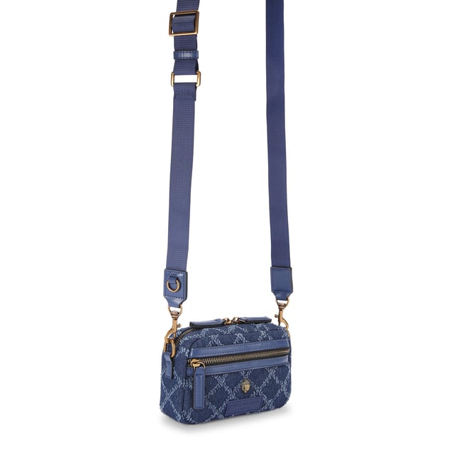 This Extra Small Denim Cross bag features a blue denim exterior with frayed diamond weave design. There is an antiqued brass eagle head on the front above a rubber branded patch. 19cm (H), 18cm (L), 5cm (D). Strap length: 120cm. Removable cross body woven strap. Can fit phones up to 6inches.