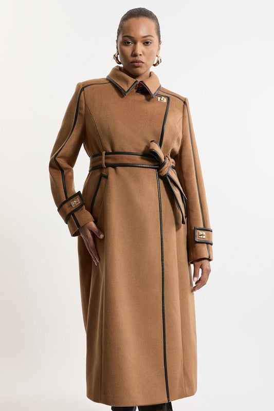 Feel elevated no matter the weather in our plus size midi length coat, made in high quality, thick wool, featuring a fit that flatters the figure and faux leather trims. Wear it over any outfit, whether heading out for dinner or to the office. Plus Size Wool Blend Faux Leather Trim Belted Tailored Midi Coat High Quality Wool Blend Fabric Flattering Fitted Bodice Straight Hanging Skirt Metallic Clasp Buttons at Collar and Cuffs High, Collared Neckline Belted Waistline Unique, Faux Leather Trims Expertly designed for those UK size 18/US size 14 and above, our plus size clothing collection is perfectly proportioned to ensure you look stylish at every shape. Discover our collection of plus size coats and jackets or browse our range of plus size clothing now.