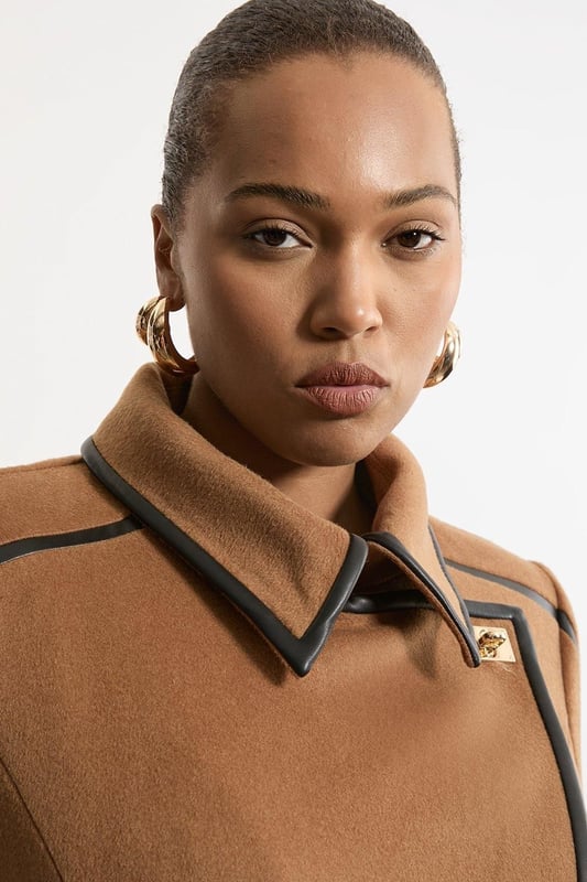 Feel elevated no matter the weather in our plus size midi length coat, made in high quality, thick wool, featuring a fit that flatters the figure and faux leather trims. Wear it over any outfit, whether heading out for dinner or to the office. Plus Size Wool Blend Faux Leather Trim Belted Tailored Midi Coat High Quality Wool Blend Fabric Flattering Fitted Bodice Straight Hanging Skirt Metallic Clasp Buttons at Collar and Cuffs High, Collared Neckline Belted Waistline Unique, Faux Leather Trims Expertly designed for those UK size 18/US size 14 and above, our plus size clothing collection is perfectly proportioned to ensure you look stylish at every shape. Discover our collection of plus size coats and jackets or browse our range of plus size clothing now.