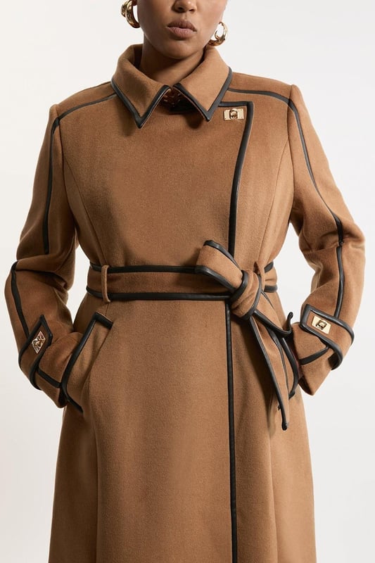Feel elevated no matter the weather in our plus size midi length coat, made in high quality, thick wool, featuring a fit that flatters the figure and faux leather trims. Wear it over any outfit, whether heading out for dinner or to the office. Plus Size Wool Blend Faux Leather Trim Belted Tailored Midi Coat High Quality Wool Blend Fabric Flattering Fitted Bodice Straight Hanging Skirt Metallic Clasp Buttons at Collar and Cuffs High, Collared Neckline Belted Waistline Unique, Faux Leather Trims Expertly designed for those UK size 18/US size 14 and above, our plus size clothing collection is perfectly proportioned to ensure you look stylish at every shape. Discover our collection of plus size coats and jackets or browse our range of plus size clothing now.