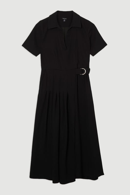 This Karen Millen soft tailored midi dress strikes the perfect balance between professional polish and feminine charm. The classic collared design and pleated detailing create a sophisticated silhouette that commands attention in any boardroom or office setting. Style with pointed court shoes and a structured tote for daytime meetings, or transition to evening networking events with statement earrings and a sleek clutch. The belted waist offers customisable definition, whilst the midi length ensures appropriate coverage for formal workplace settings. This versatile piece works beautifully layered under a tailored blazer during cooler months or worn alone when temperatures rise. A timeless addition to your workwear rotation that delivers effortless elegance with practical comfort.  Elegant collared neckline with a sophisticated V-opening for a refined workwear silhouette Short sleeves offering comfortable coverage whilst maintaining a professional appearance Stylish D-ring belt detail that cinches the waist for a flattering, feminine shape Graceful pleated skirt with a flowing midi length that creates elegant movement Practical side pockets discreetly integrated into the design for functionality