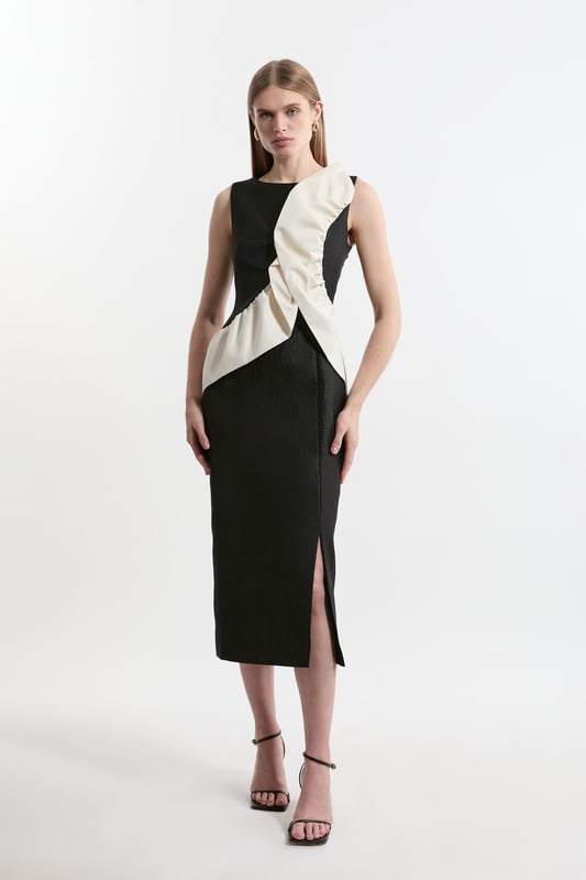 Make a statement in our midi dress, featuring a fit that hugs the curves, with a ruffle accent across the bodice. Style this dress with strappy heels for an outfit that will turn heads from wedding guest nights to upcoming occasions and events. Textured Tailored Contrast Taffeta Ruffle Midi Dress High Quality Taffeta Fabric Statement Ruffle Accent Across Bodice and Shoulder Flattering Figure Hugging Silhouette Thigh High Leg Split Zip Fastening in BackDiscover this seasons party dresses or browse the full colleciton of women's dresses now.