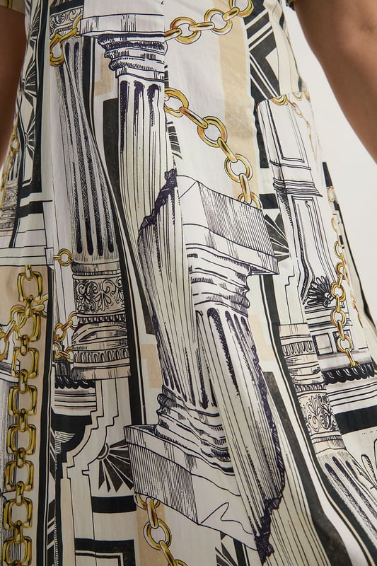 Striking Roma print featuring architectural motifs and chain details Flattering V-neckline and short sleeves Full skirt design for a dramatic silhouette Midi length perfect for various occasions Crafted from soft cotton sateen for comfort and style  Make a statement in this eye-catching Karen Millen plus size midi dress. The Roma print, adorned with architectural elements and chain motifs, creates a captivating visual impact. The V-neckline and short sleeves offer a flattering frame, while the full skirt adds a touch of drama to your ensemble. Perfect for daytime events, this dress can be styled with flat sandals and a tote bag for a casual lunch date or family gathering. Layer with a denim jacket for a more relaxed look, or add a belt to accentuate your waist. The versatile midi length allows for easy transition from day to evening, making it a go-to piece for various occasions. Embrace the artistic print and let this dress become the focal point of your outfit, pairing it with minimal accessories to let the design truly shine.