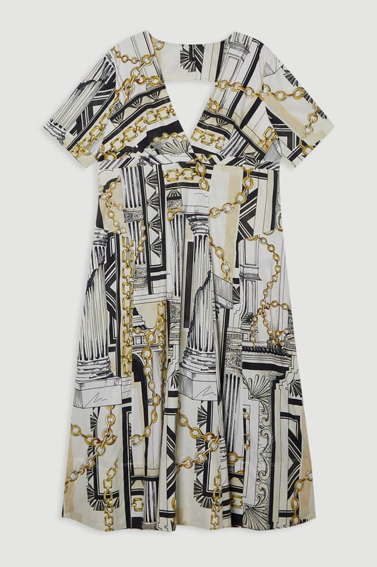 Striking Roma print featuring architectural motifs and chain details Flattering V-neckline and short sleeves Full skirt design for a dramatic silhouette Midi length perfect for various occasions Crafted from soft cotton sateen for comfort and style  Make a statement in this eye-catching Karen Millen plus size midi dress. The Roma print, adorned with architectural elements and chain motifs, creates a captivating visual impact. The V-neckline and short sleeves offer a flattering frame, while the full skirt adds a touch of drama to your ensemble. Perfect for daytime events, this dress can be styled with flat sandals and a tote bag for a casual lunch date or family gathering. Layer with a denim jacket for a more relaxed look, or add a belt to accentuate your waist. The versatile midi length allows for easy transition from day to evening, making it a go-to piece for various occasions. Embrace the artistic print and let this dress become the focal point of your outfit, pairing it with minimal accessories to let the design truly shine.