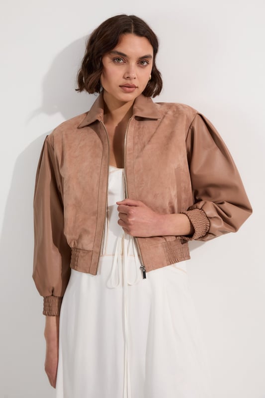 This Karen Millen suede and leather mix bomber jacket is a versatile piece that effortlessly bridges the gap between casual and chic. The boxy fit creates a modern, relaxed silhouette that's perfect for everyday wear. Style it with a floaty white dress for a striking contrast in textures or for a more casual daytime look; pair it with your favourite jeans and a simple tee. The jacket's versatility shines through when worn to family gatherings or casual brunches with friends. Complete the ensemble with some statement flats or ankle boots for a touch of edgy sophistication. The collared neckline and elasticated hem add both style and functionality, ensuring you stay comfortable and fashionable throughout the day. This bomber jacket is a wardrobe essential that will quickly become your go-to outerwear for those in-between seasons.  Luxurious suede and leather mix bomber jacket Boxy fit for a contemporary silhouette Collared neckline adds a classic touch Elasticated hem for a snug fit Perfect for layering
