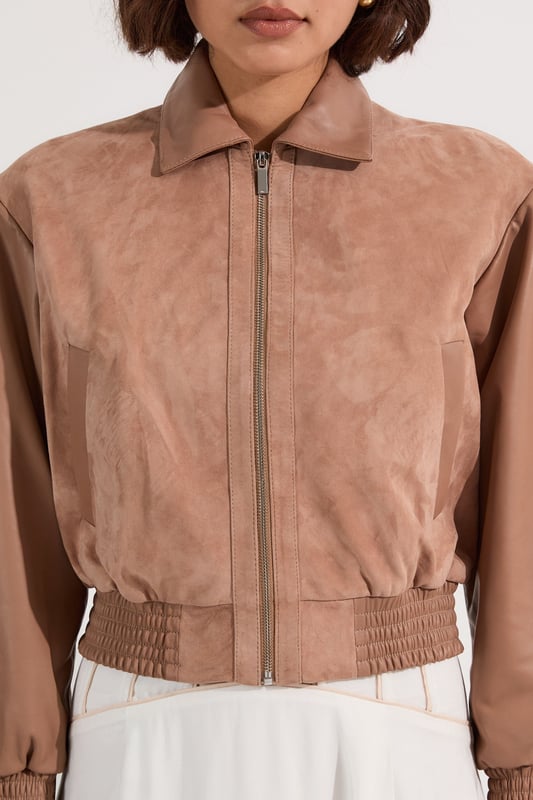 This Karen Millen suede and leather mix bomber jacket is a versatile piece that effortlessly bridges the gap between casual and chic. The boxy fit creates a modern, relaxed silhouette that's perfect for everyday wear. Style it with a floaty white dress for a striking contrast in textures or for a more casual daytime look; pair it with your favourite jeans and a simple tee. The jacket's versatility shines through when worn to family gatherings or casual brunches with friends. Complete the ensemble with some statement flats or ankle boots for a touch of edgy sophistication. The collared neckline and elasticated hem add both style and functionality, ensuring you stay comfortable and fashionable throughout the day. This bomber jacket is a wardrobe essential that will quickly become your go-to outerwear for those in-between seasons.  Luxurious suede and leather mix bomber jacket Boxy fit for a contemporary silhouette Collared neckline adds a classic touch Elasticated hem for a snug fit Perfect for layering