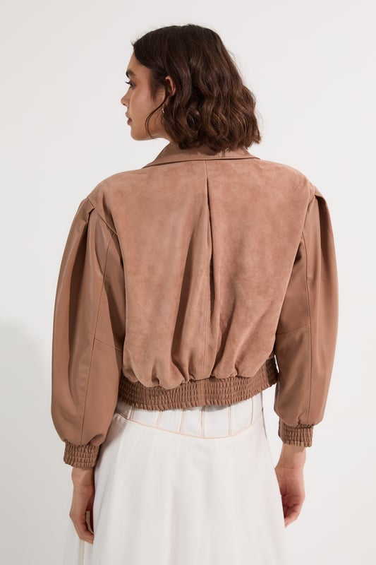 This Karen Millen suede and leather mix bomber jacket is a versatile piece that effortlessly bridges the gap between casual and chic. The boxy fit creates a modern, relaxed silhouette that's perfect for everyday wear. Style it with a floaty white dress for a striking contrast in textures or for a more casual daytime look; pair it with your favourite jeans and a simple tee. The jacket's versatility shines through when worn to family gatherings or casual brunches with friends. Complete the ensemble with some statement flats or ankle boots for a touch of edgy sophistication. The collared neckline and elasticated hem add both style and functionality, ensuring you stay comfortable and fashionable throughout the day. This bomber jacket is a wardrobe essential that will quickly become your go-to outerwear for those in-between seasons.  Luxurious suede and leather mix bomber jacket Boxy fit for a contemporary silhouette Collared neckline adds a classic touch Elasticated hem for a snug fit Perfect for layering