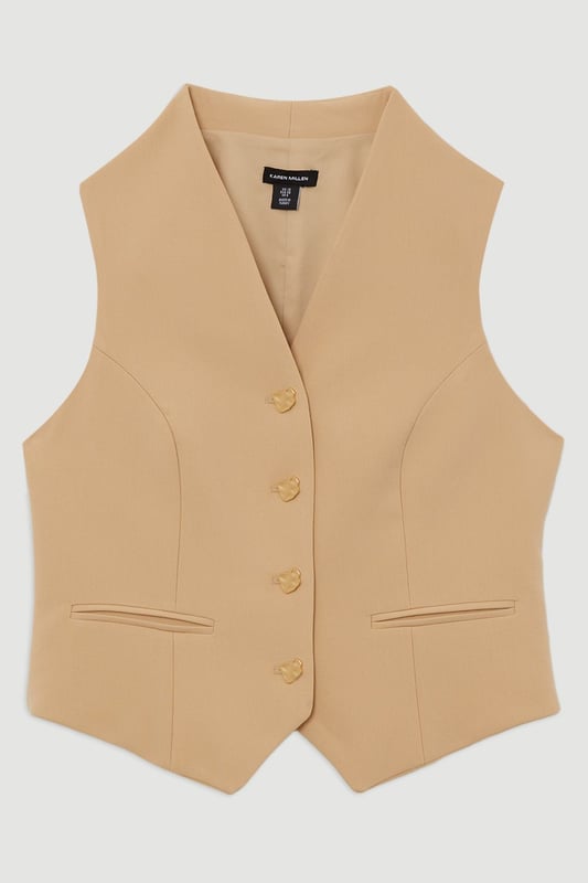 Elevate your top selection with our waistcoat, with a figure hugging fit, and buttons down the front. This piece pairs well with anything, from matching separates, to tailored trousers, to jeans for an elevated look that will take you seamlessly from day to night. Essential Tailored Button Through Waistcoat Classic Waistcoat Style V Neckline Fitted Silhouette Sleek, Minimal Design Button Front Fastening Matching Trousers Sold Separately