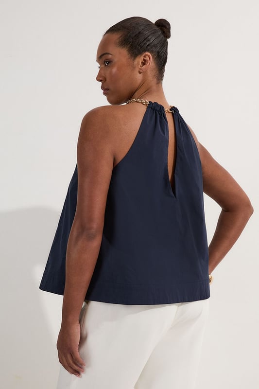 Striking halterneck design with bold chain detail Sleeveless silhouette for a breezy, summer-ready look Relaxed fit through the body for effortless comfort Keyhole detail at the neckline adds a touch of allure Versatile cotton-blend fabric suitable for various occasions  This Karen Millen plus size halter top is a must-have addition to your warm-weather wardrobe. The eye-catching chain detail at the neckline lends a touch of glamour to this otherwise casual piece, making it perfect for a variety of daytime events. Style it with high-waisted trousers and flat sandals for a chic look at family gatherings or weekend brunches. For a more laid-back approach, pair it with your favourite denim shorts and trainers for a day of shopping or a casual catch-up with friends. The relaxed fit and breathable fabric ensure all-day comfort, while the sleeveless design keeps you cool during those balmy summer days. This versatile top can easily transition from day to night - simply swap your flats for a pair of wedges and add some statement earrings for an effortless evening ensemble.