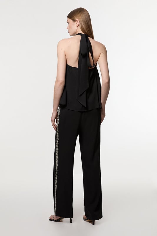 Experience sleek tailoring in a pair of straight leg trousers, with a flattering, relaxed fit and a comfortable high waistline. The sparkling embellishments are hand placed and make for a striking occasion look. Style it with the matching top for a co-ordinating look, or with a blazer and boots for a more laid back approach. Hand Embellished Cady Woven Trouser High Quality Tailored Design Comfortable High Waistline Flattering Straight Leg Fit Sparkling Hand Embellished Strip Down Sides Pocket Accents Matching Top Sold SeparatelyDiscover our collection of occasion wear or browse our range of women's occasion dresses now.