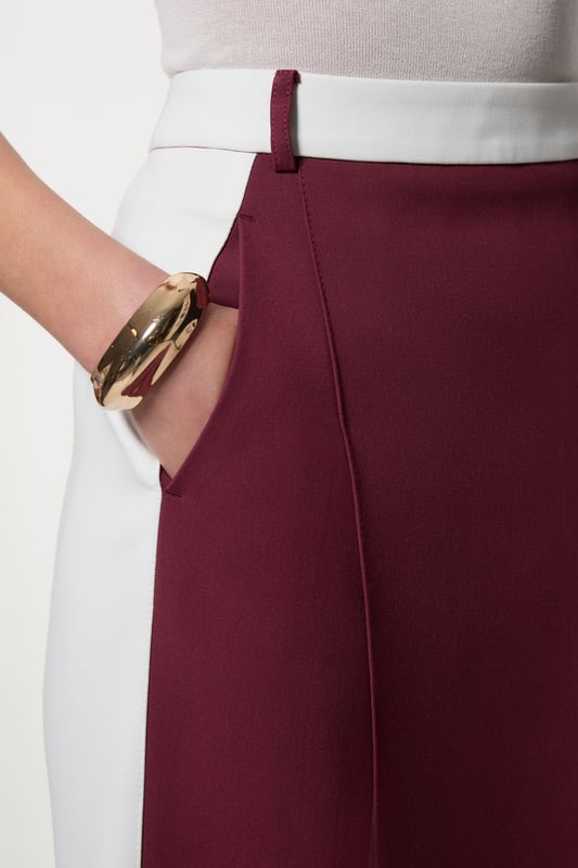 Experience updated tailoring essentials with our midi skirt, with a fitted silhouette and a high waistline, creating a universally flattering fit. The contrasting trims make for a bold outfit, especially when paired with the matching blazer for a striking office look.  Compact Stretch Contrast Waistband Pencil Midi Skirt High Quality Stretch Fabric Comfortable High Waistline Flattering Fitted Silhouette Contrasting Panel Detailing Thigh High Leg Split in Back Zip Back Fastening Matching Blazer Sold Separately