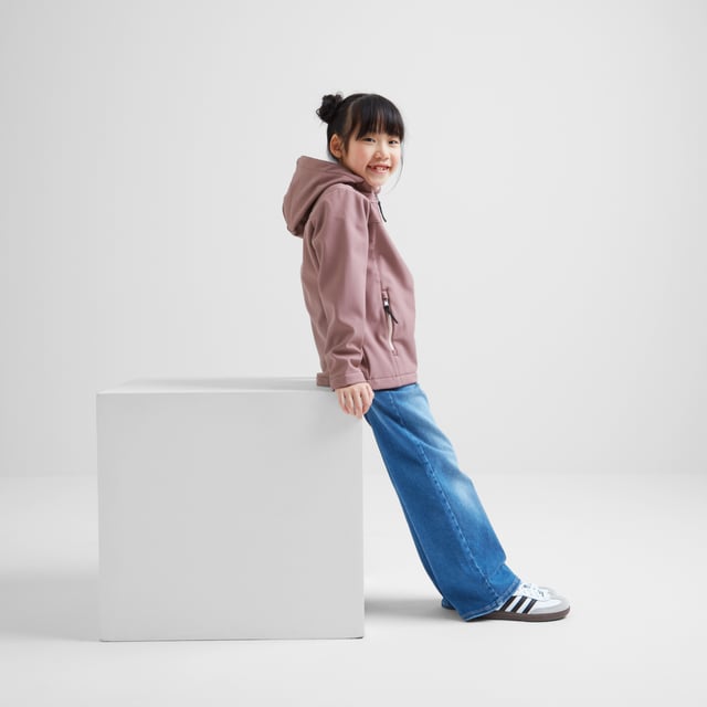 Active kids love our Koroma softshell jacket that gives protection from the elements, but doesn't restrict movement. Designed in Yorkshire, where we know just how changeable the weather can be, this versatile jacket has a durable, water resistant, windproof and fully breathable outer, a fixed, shaped, adjustable hood and a cosy, bonded inner fleece. Koroma has two handy zip pockets to keep all those essentials safe and a full length front zip with a chunky puller. It comes in dark and bright colours, so it works as a school coat and for weekends too. This lightweight jacket is finished with our signature embossed rubber Yorkshire Rose badge on the sleeve and a printed TOG24 logo on the chest.