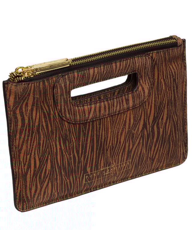 The 'Esher' clutch bag from Pure Luxuries London is handcrafted from luxurious natural leather with a beautifully suede finish. The dual zips, above the built-in handles, secure the dual compartments that come lined with natural, untreated 100% cotton. Additional storage space is provided by a central slip pocket between the zipped compartments, ideal for on-the-go storage. Adorned with the iconic Pure Luxuries London gold foil embossed logo as the perfect finishing touch.