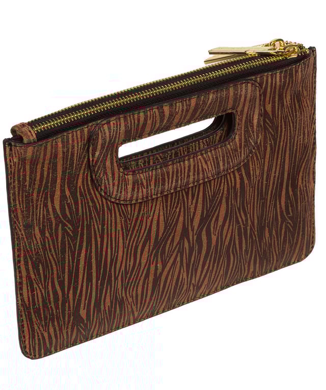 The 'Esher' clutch bag from Pure Luxuries London is handcrafted from luxurious natural leather with a beautifully suede finish. The dual zips, above the built-in handles, secure the dual compartments that come lined with natural, untreated 100% cotton. Additional storage space is provided by a central slip pocket between the zipped compartments, ideal for on-the-go storage. Adorned with the iconic Pure Luxuries London gold foil embossed logo as the perfect finishing touch.