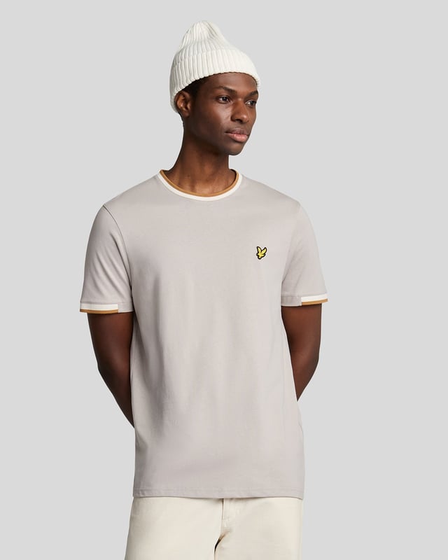 Introducing the Half Tipped T-Shirt, an exquisite addition to our Legacy range of short sleeve apparel. This refined piece is designed with a tipped contrast collar and half-tipped cuffs, imparting a distinctive flair that elevates casual elegance. Crafted from 100% premium cotton, it ensures comfort while showcasing a golden embroidered eagle on the top left chest, symbolizing sophistication.

- Composition: 100% Cotton
- Fit: Regular
- Logo Branding: Golden embroidered eagle
- Logo Branding Garment Location: Top left chest
- Versatile styling for both casual and semi-formal occasions

Elevate your spring menswear collection with this distinguished t-shirt, epitomizing modern style and timeless luxury.