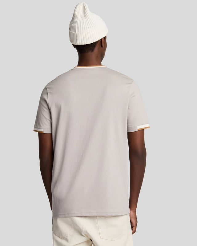 Introducing the Half Tipped T-Shirt, an exquisite addition to our Legacy range of short sleeve apparel. This refined piece is designed with a tipped contrast collar and half-tipped cuffs, imparting a distinctive flair that elevates casual elegance. Crafted from 100% premium cotton, it ensures comfort while showcasing a golden embroidered eagle on the top left chest, symbolizing sophistication.

- Composition: 100% Cotton
- Fit: Regular
- Logo Branding: Golden embroidered eagle
- Logo Branding Garment Location: Top left chest
- Versatile styling for both casual and semi-formal occasions

Elevate your spring menswear collection with this distinguished t-shirt, epitomizing modern style and timeless luxury.
