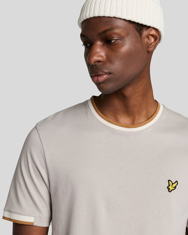 Introducing the Half Tipped T-Shirt, an exquisite addition to our Legacy range of short sleeve apparel. This refined piece is designed with a tipped contrast collar and half-tipped cuffs, imparting a distinctive flair that elevates casual elegance. Crafted from 100% premium cotton, it ensures comfort while showcasing a golden embroidered eagle on the top left chest, symbolizing sophistication.

- Composition: 100% Cotton
- Fit: Regular
- Logo Branding: Golden embroidered eagle
- Logo Branding Garment Location: Top left chest
- Versatile styling for both casual and semi-formal occasions

Elevate your spring menswear collection with this distinguished t-shirt, epitomizing modern style and timeless luxury.