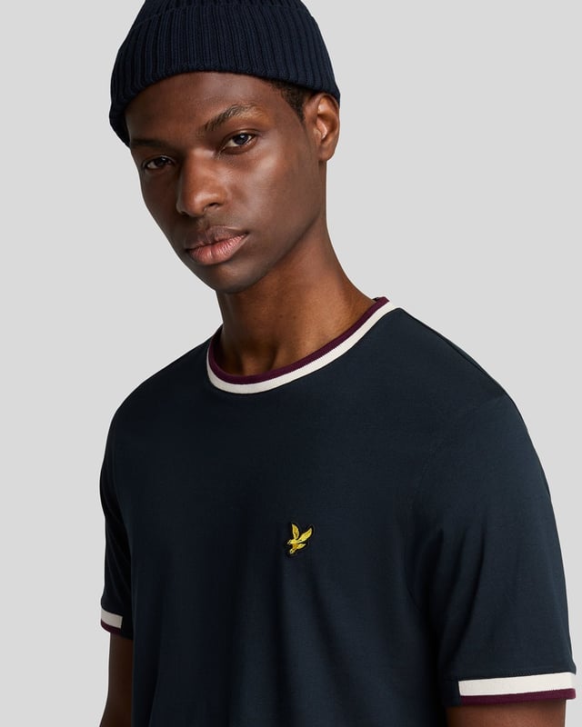 Introducing the Half Tipped T-Shirt, an exquisite addition to our Legacy range of short sleeve apparel. This refined piece is designed with a tipped contrast collar and half-tipped cuffs, imparting a distinctive flair that elevates casual elegance. Crafted from 100% premium cotton, it ensures comfort while showcasing a golden embroidered eagle on the top left chest, symbolizing sophistication.

- Composition: 100% Cotton
- Fit: Regular
- Logo Branding: Golden embroidered eagle
- Logo Branding Garment Location: Top left chest
- Versatile styling for both casual and semi-formal occasions

Elevate your spring menswear collection with this distinguished t-shirt, epitomizing modern style and timeless luxury.