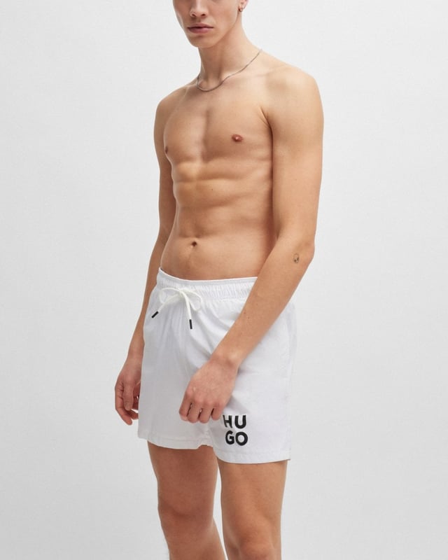 Sleek quick-drying swim shorts by HUGO Menswear. Featuring full lining and a drawcord waist, this pair is printed with a stacked HUGO logo. This product is created with recycled polyamide made from pre- and post-consumer textile waste or industrial fishing nets.
Material information: 100% Polyamid, Lining: 100% Polyester, Inner lining: 100% Polyester
50510190