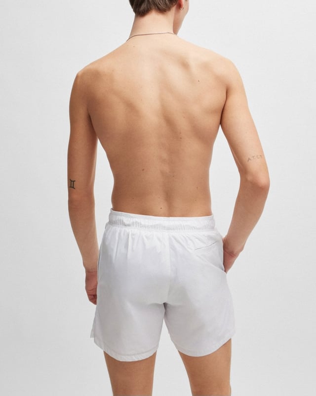 Sleek quick-drying swim shorts by HUGO Menswear. Featuring full lining and a drawcord waist, this pair is printed with a stacked HUGO logo. This product is created with recycled polyamide made from pre- and post-consumer textile waste or industrial fishing nets.
Material information: 100% Polyamid, Lining: 100% Polyester, Inner lining: 100% Polyester
50510190