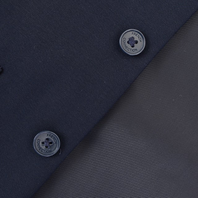 French Connection Mens Wedding Navy Waistcoat 100% Polyester. This V-neck waistcoat comes with a button placket, a contrasting back with an adjustable cinch, and pocket details.