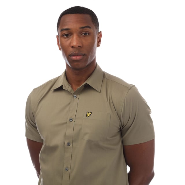 Mens Lyle And Scott Short Sleeve Poplin Shirt in olive.- Classic collar.- Short sleeves.- Full button fastening.- Chest pocket.- Lyle And Scott Golden Eagle logo patch embroidered on the pocket.- Curved hem.- 97% Cotton  3% Elastane.- Ref: SW1807VW908