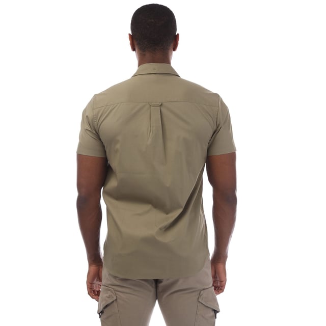 Mens Lyle And Scott Short Sleeve Poplin Shirt in olive.- Classic collar.- Short sleeves.- Full button fastening.- Chest pocket.- Lyle And Scott Golden Eagle logo patch embroidered on the pocket.- Curved hem.- 97% Cotton  3% Elastane.- Ref: SW1807VW908