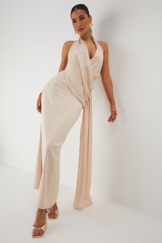 Luxurious satin fabric with a subtle sheen that catches the light beautifully
        Elegant halterneck design with an open back for a striking silhouette
        Sophisticated draped detailing along the side creates flattering movement
        Floor-sweeping maxi length with a daring side split for ease of movement
        Figure-enhancing fit with a smooth lining for comfort and confidence
    
    Command attention at your next special occasion in this show-stopping satin maxi dress from MissPap. The halterneck design frames your dcolletage whilst the open back adds a touch of drama to your ensemble. The expertly crafted side draping creates a flattering silhouette that flows with your every move, whilst the daring side split offers both practicality and allure. Style with strappy metallic heels as seen on our model and statement earrings for a head-turning look perfect for weddings, formal events or graduation ceremonies. For cooler evenings, pair with a delicate shawl or a tailored blazer to maintain the dress's elegant lines. This versatile piece transitions effortlessly from daytime celebrations to evening affairs, ensuring you remain the focal point of any occasion.