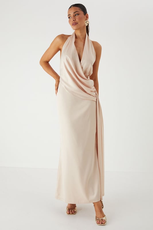 Luxurious satin fabric with a subtle sheen that catches the light beautifully
        Elegant halterneck design with an open back for a striking silhouette
        Sophisticated draped detailing along the side creates flattering movement
        Floor-sweeping maxi length with a daring side split for ease of movement
        Figure-enhancing fit with a smooth lining for comfort and confidence
    
    Command attention at your next special occasion in this show-stopping satin maxi dress from MissPap. The halterneck design frames your dcolletage whilst the open back adds a touch of drama to your ensemble. The expertly crafted side draping creates a flattering silhouette that flows with your every move, whilst the daring side split offers both practicality and allure. Style with strappy metallic heels as seen on our model and statement earrings for a head-turning look perfect for weddings, formal events or graduation ceremonies. For cooler evenings, pair with a delicate shawl or a tailored blazer to maintain the dress's elegant lines. This versatile piece transitions effortlessly from daytime celebrations to evening affairs, ensuring you remain the focal point of any occasion.