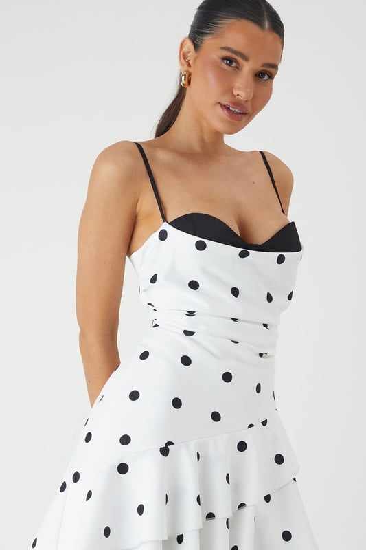 Striking sweetheart neckline with contrasting trim for a bold statement
        Asymmetric layered frill design creates dramatic movement and visual interest
        Elegant maxi length with high-low hemline for a contemporary silhouette
        Adjustable thin straps for a customised and secure fit
        Playful polka dot pattern adds a timeless charm to this occasion piece
    
    Make an unforgettable entrance in this show-stopping polka dot maxi dress from MissPap. The layered frill construction cascades beautifully to create a flattering asymmetric hemline that dances with your every move. The structured sweetheart neckline with its contrasting trim frames your dcolletage perfectly, whilst the fitted bodice cinches the waist for a feminine silhouette. Style with strappy heels and statement earrings as seen on our model for formal events such as weddings or race days. For evening soires, add a sleek clutch and a bold red lip to command attention. This versatile piece transitions effortlessly from daytime garden parties to evening celebrations - simply switch your accessories to reflect the occasion's formality. The lightweight woven fabric ensures comfort without compromising on sophistication.
