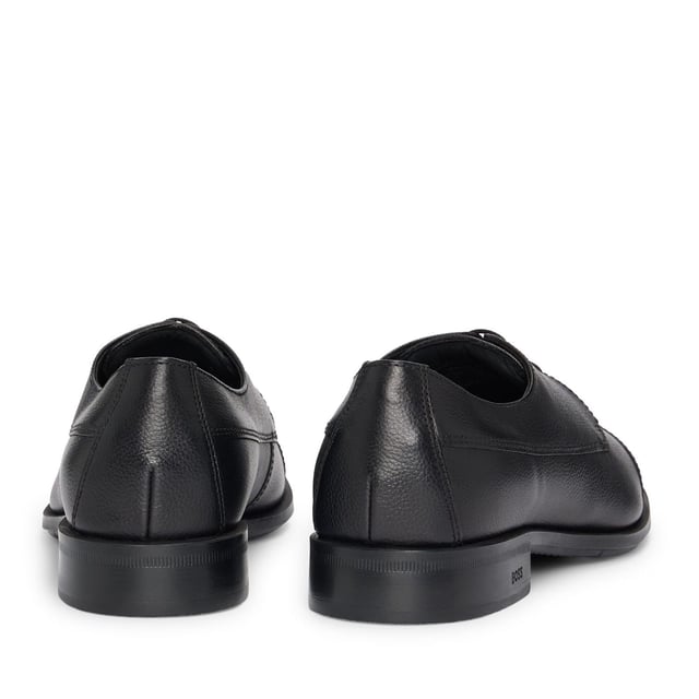 Men's Hugo Boss Colby Derby Shoes in Black Classic cap toe derby in grainy leather. Comfortable and versatile shoes born to perfectly match every business and formal outfit thanks to the clean design enriched by details like the double stitching on the quarter or the branding on the sole. Responsible product.